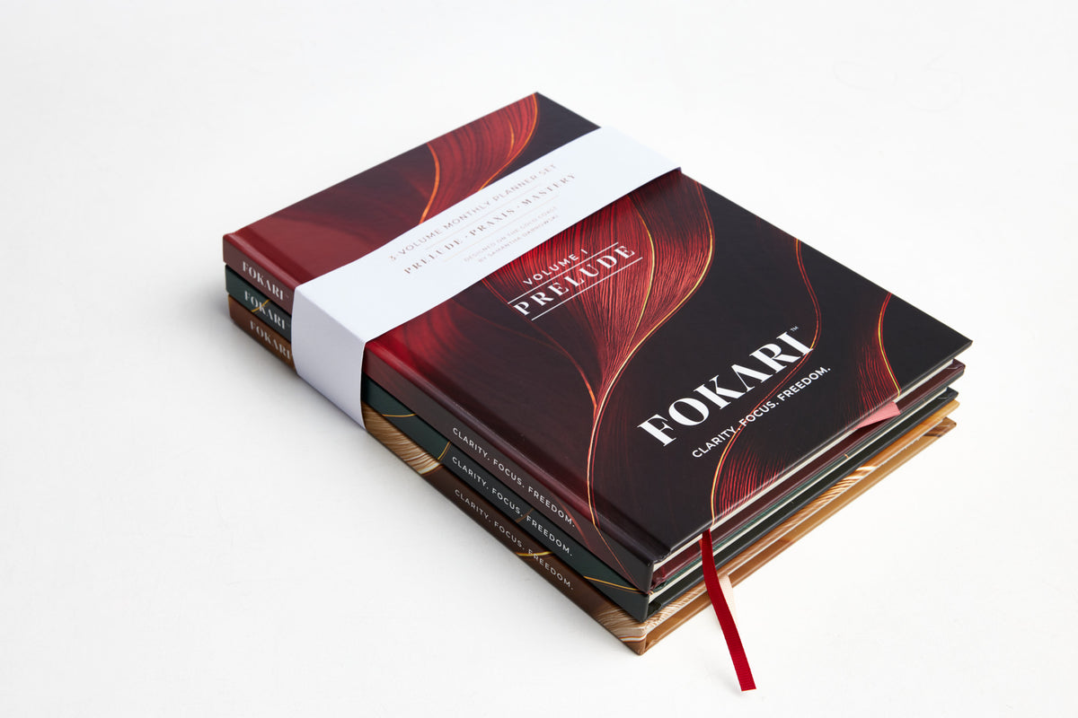 Fokari planner volumes stacked with gold belly band